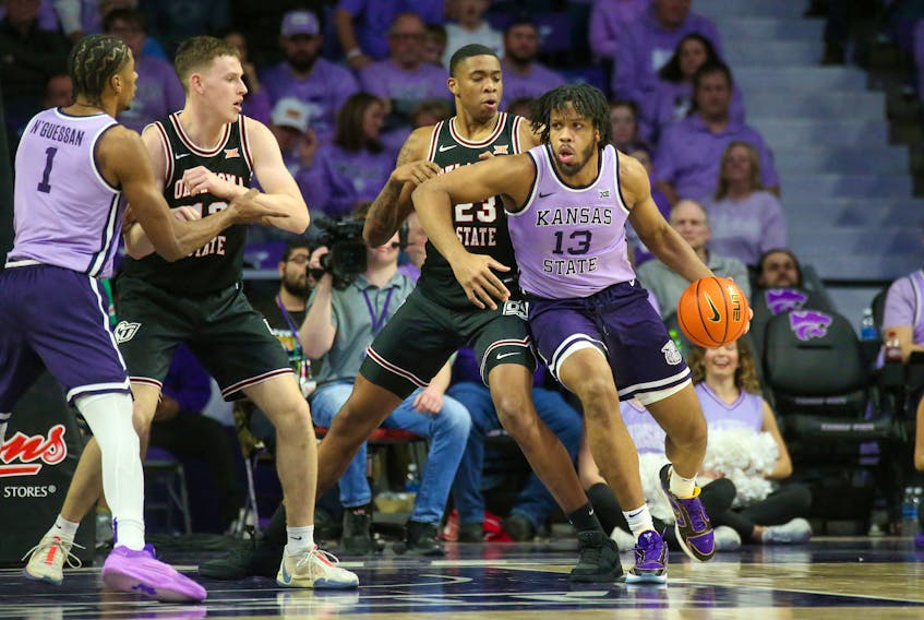 Jan 20, 2024; Manhattan, Kansas, USA; Kansas State Wildcats center Will McNair Jr. (13) is guarded by Oklahoma State Cowboys center Brandon Garrison (23) during the second half at Bramlage Coliseum. Mandatory Credit: Scott Sewell-USA TODAY Sports