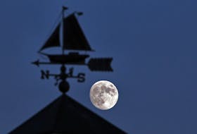 FOR NEWS STANDALONE:
An approaching full moon (2 days away) is framed by a weather vane atop the cupola on a gift shop in Eastern Passage, Monday November 26, 2012.

TIM KROCHAK/ Staff