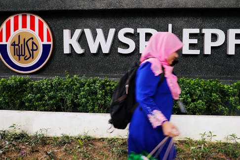 A woman walks past the Employees' Provident Fund (EPF) headquarters in Kuala Lumpur, Malaysia September 5, 2019. 
