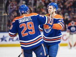 Connor McDavid and Leon Draisaitl celebrate an overtime goal against the Arizona Coyotes  in Edmonton on March 22, 2023.