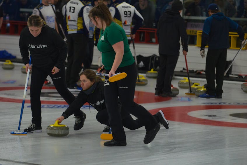 Skip Jane DiCarlo makes a shot as lead Whitney Jenkins, left, and second stone Sabrina Smith, right, prepare to sweep during the P.E.I. Scotties Tournament of Hearts women’s A section final during the afternoon draw on Jan. 26. DiCarlo defeated Tammy Dewar of the Montague Curling Club 6-1 to improve to 3-0 (won-lost). Jason Simmonds • The Guardian