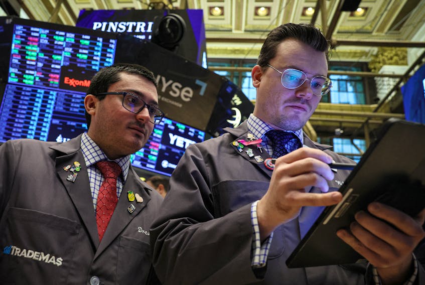 Traders work on the floor at the New York Stock Exchange (NYSE) in New York City, U.S., January 19, 2024. 