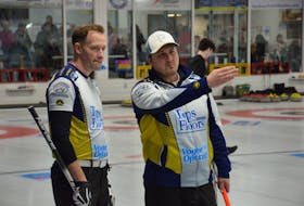Tim Hockin, left, and Darren Higgins discuss strategy during a game against the Jamie Newson rink in the P.E.I. Tankard men’s curling championship at the Silver Fox Entertainment Complex in Summerside on Jan. 25. Higgins calls the game and throws third stones while Hockin handles skip rocks for the Summerside-based team. Team Higgins won the game 9-5 to improve to 2-0. Play in the seven-team modified triple-knockout continues throughout the weekend. Jason Simmonds • The Guardian