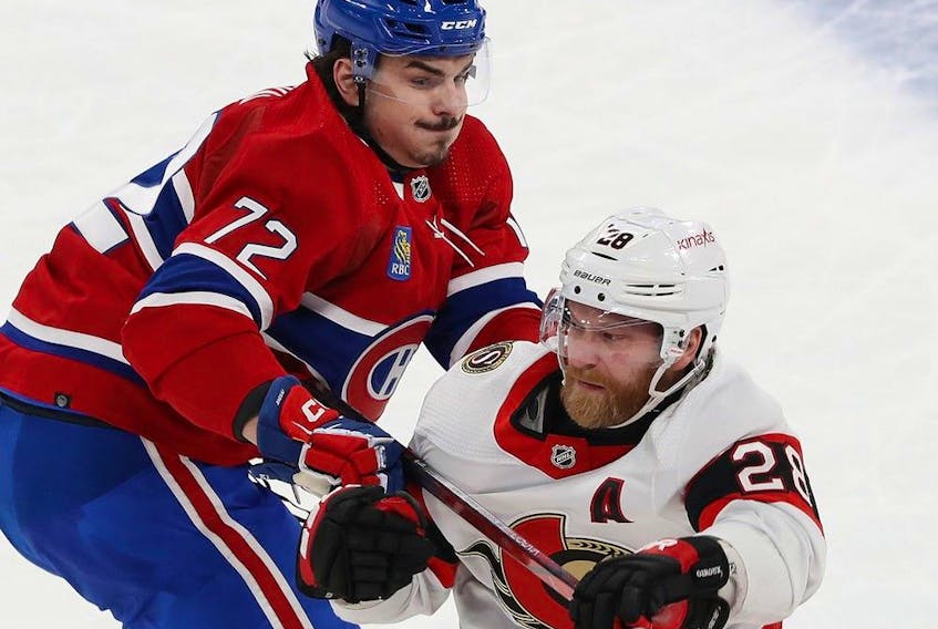 Ottawa Senators' Claude Giroux (28) tries to pull away from Montreal Canadiens' Arber Xhekaj (72) in Montreal on Jan. 23, 2024.