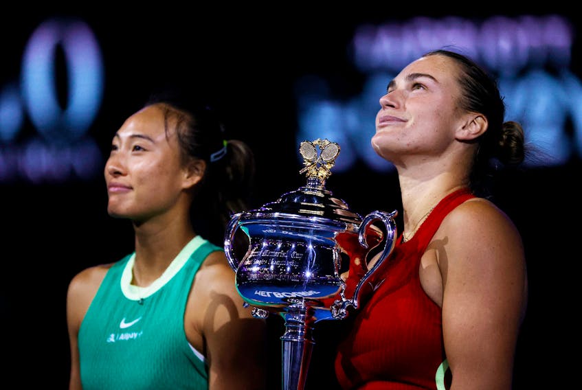 Tennis - Australian Open - Melbourne Park, Melbourne, Australia - January 27, 2024 Belarus' Aryna Sabalenka poses for a picture with the trophy after winning the final alongside runner up China's Qinwen Zheng