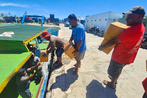 Men carry ballot boxes in preparation for the general elections on Friday, in Funafuti, Tuvalu January 22, 2024. Tuvalu Election Office/Handout via