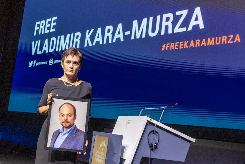 Evgenia Kara-Murza, wife of jailed Russian opposition figure Vladimir Kara-Murza, poses with a picture of her husband after her address for the opening of the Geneva Summit for Human Rights and Democracy in Geneva, Switzerland May 17, 2023.