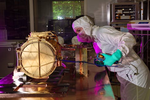 An electrical engineer performs an electrical grounding test on Europa Clipper’s SUrface Dust Analyzer (SUDA) sensor head at the Laboratory for Atmospheric and Space Physics (LASP) at the University of Colorado Boulder in August 2022. SUDA will study the tiny meteorites ejected from Europa’s surface into space and identify their chemistry to determine Europa’s surface composition, including potential organic molecules. - NASA image