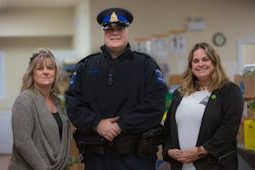 Colchester Food Bank Executive Director Shelly Deviller, left, enlisted the help of Const. Terry Moser from the Truro Police Service, center, and United Way Colchester to help heighten the security of the food bank with cameras, lights and signage. Also pictured is Sarah Fleming, executive director of United Way Colchester. Nick Gaines