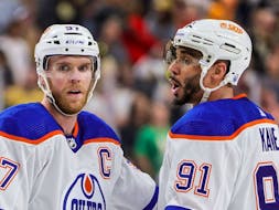 Connor McDavid (97) and Evander Kane (91) of the Edmonton Oilers talk after a timeout in Game 5 of their playoff round against the Vegas Golden Knights at T-Mobile Arena on May 12, 2023, in Las Vegas, Nev.