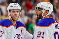 Connor McDavid (97) and Evander Kane (91) of the Edmonton Oilers talk after a timeout in Game 5 of their playoff round against the Vegas Golden Knights at T-Mobile Arena on May 12, 2023, in Las Vegas, Nev.