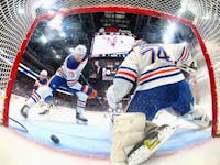 Vincent Desharnais (73) and Stuart Skinner (74) of the Edmonton Oilers defend the net against the New York Islanders at UBS Arena on Dec. 19, 2023, in Elmont, N.Y.