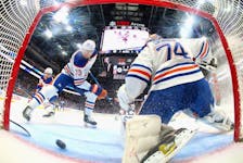 Vincent Desharnais (73) and Stuart Skinner (74) of the Edmonton Oilers defend the net against the New York Islanders at UBS Arena on Dec. 19, 2023, in Elmont, N.Y.