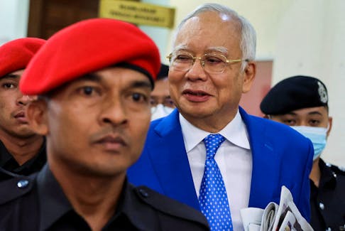Former Malaysian Prime Minister Najib Razak is escorted by prison officers as the jailed politician leaves the court after court proceedings in Kuala Lumpur, Malaysia January 19, 2024.