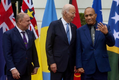 U.S. President Joe Biden chats with President of Kiribati Taneti Maamau as Prime Minister of the Cook Islands Mark Brown stands next to them while Pacific Island nation leaders pose for a group photograph during a summit at the White House in Washington, U.S., September 25, 2023.