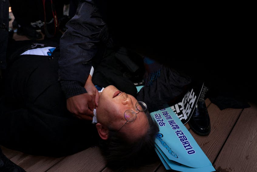 South Korea's opposition Democratic Party leader Lee Jae-myung falls after being attacked by an unidentified man during his visit to Busan, South Korea, January 2, 2024.    Yonhap via REUTERS