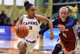 Chermensa Van La Parra of the Cape Breton Capers, right, works her way to the basket during Atlantic University Sport women's basketball action at Sullivan Field House in Sydney on Friday. The Acadia Axewomen won the game 83-81. CONTRIBUTED/VAUGHAN MERCHANT, CBU ATHLETICS.