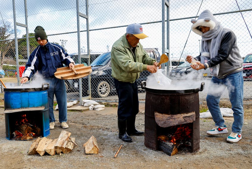 Staff members of Takeuchi Farm, who come from Okayama Prefecture to voluntarily help evacuees, cook food for the evacuees at an evacuation centre, in the aftermath of an earthquake, in Wajima, Ishikawa Prefecture, Japan, January 5, 2024.