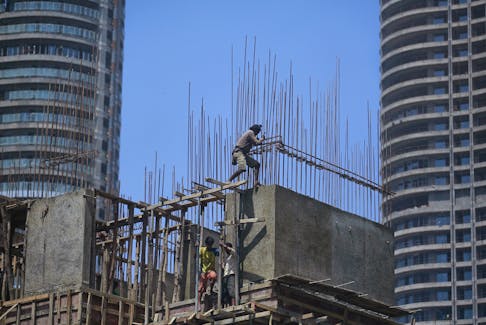 Labourers work at the construction site of a residential building in Mumbai's central financial district April 6, 2015.REUTERS/Danish Siddiqui/File Photo