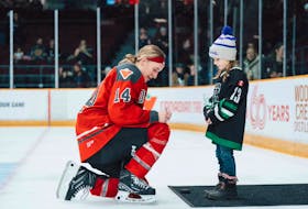 Ottawa player Hayley Scamurra of the PWHL signs an autograph during the team's opening night hosting Montreal Jan. 2 before a crowd of more than 8,300 spectators. PWHL Facebook