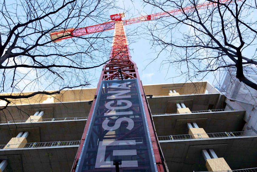 The sign of Signa Holding is placed on a crane next to a construction site in Vienna, Austria, December 19, 2023.
