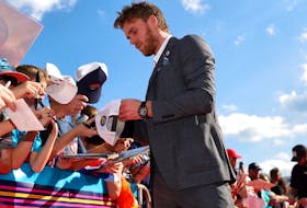 Connor McDavid of the Edmonton Oilers signs autographs for fans during the 2023 NHL All-Star Red Carpet at Fort Lauderdale Beach Park on Feb. 03, 2023, in Fort Lauderdale, Fla.