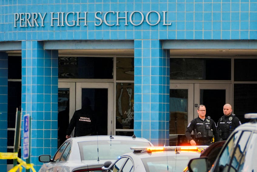 A medical examiner enters the school as police respond to a school shooting at the Perry Middle School and High School complex in Perry, Iowa, U.S., January 4, 2024. 