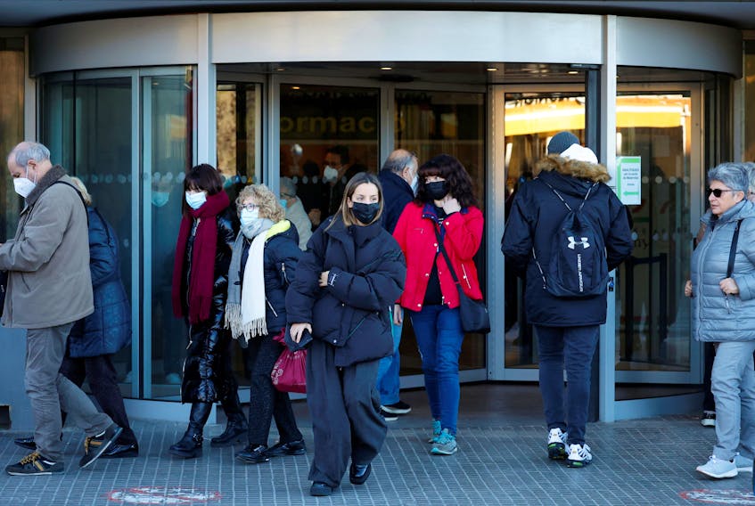 People wearing protective masks walk outside the Germans Trias i Pujol Hospital in Badalona, Spain, January 8, 2024.
