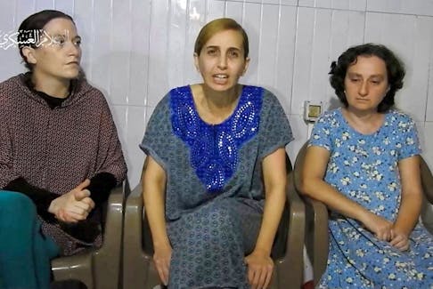 Three Israeli women, identified by Israeli Prime Minister Benjamin Netanyahu as Yelena Trupanob, Danielle Aloni and Rimon Kirsht, who are held captive by Islamist Hamas in Gaza after being abducted from Israeli homes on October 7, give a statement in this handout video grab obtained by Reuters on October 30, 2023. Al-Qassam Brigade, Military Wing of Hamas via Telegram/Handout via