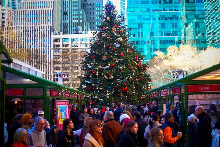 Holiday shoppers pack the seasonal Bryant Park Winter Village beneath a large Christmas tree in midtown Manhattan, in New York City, U.S., December 15, 2023.