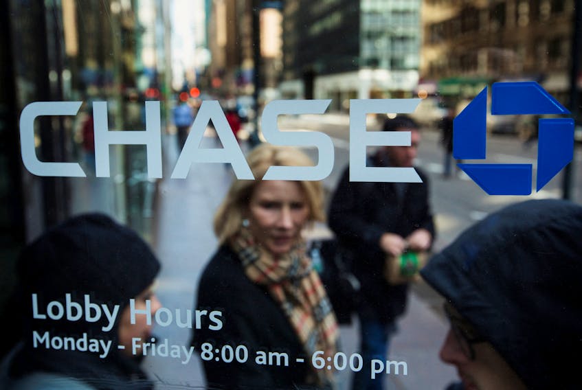 A customer walks out of a branch of the JPMorgan Chase & Co bank in New York, March 15, 2013.
