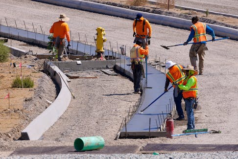 Construction work on a roadway to a residential subdivision is shown in the Rancho Penasquitos neighborhood, in San Diego, California, U.S., September 19, 2023.
