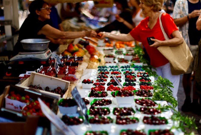 Shoppers buy fruits at a local market in Nice, France, June 8, 2023.