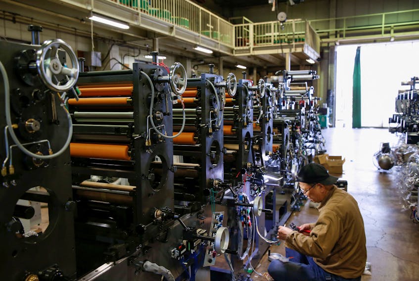 A worker checks machinery at a factory in Higashiosaka, Japan June 23, 2022. 