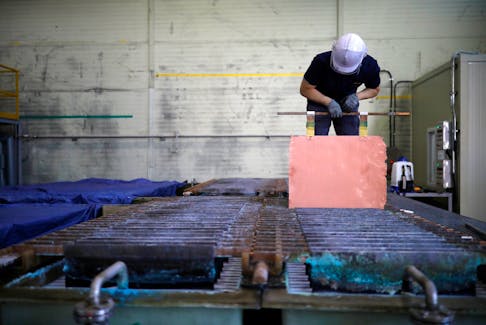 An employee holds a recycled copper plate at an urban mining plant in Gunsan, South Korea, April 2, 2018. Picture taken on April 2, 2018.  