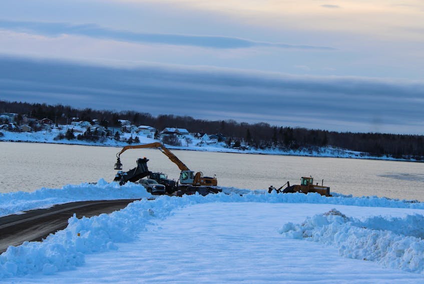 A dump truck, excavator and snowplow sit next to the Sydney harbour on Saturday. Cape Breton Regional Municipality officials said the federal government has approved an emergency request to dump snow in the harbour to speed up snow removal efforts. LUKE DYMENT/CAPE BRETON POST