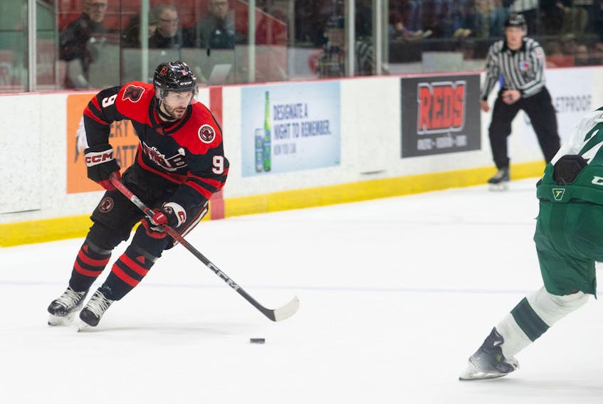 The UNB Reds’ Austen Keating, 9, carries the puck in an Atlantic University Sport (AUS) Men’s Hockey Conference game against the UPEI Panthers in Fredericton on Feb. 10. Keating scored three goals in the Reds’ 9-1 win that capped an undefeated regular season. James West/For UNB Athletics