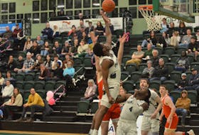 The UPEI Panthers’ Kamari Scott, white jersey, jumps in the air for a rebound during an Atlantic University Sport (AUS) Men’s Basketball Conference game against the Memorial Sea-Hawks in Charlottetown on Feb. 9. The Panthers defeated the Sea-Hawks 91-86 on Feb. 9 and 66-54 to remain in playoff contention. Jason Simmonds • The Guardian