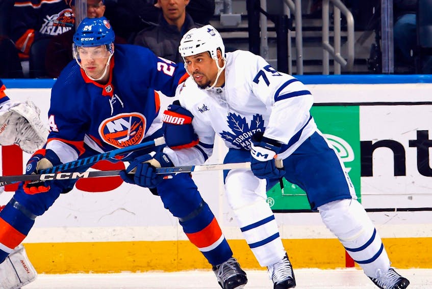 Ryan Reaves, right, of the Toronto Maple Leafs skates against the New York Islanders.
