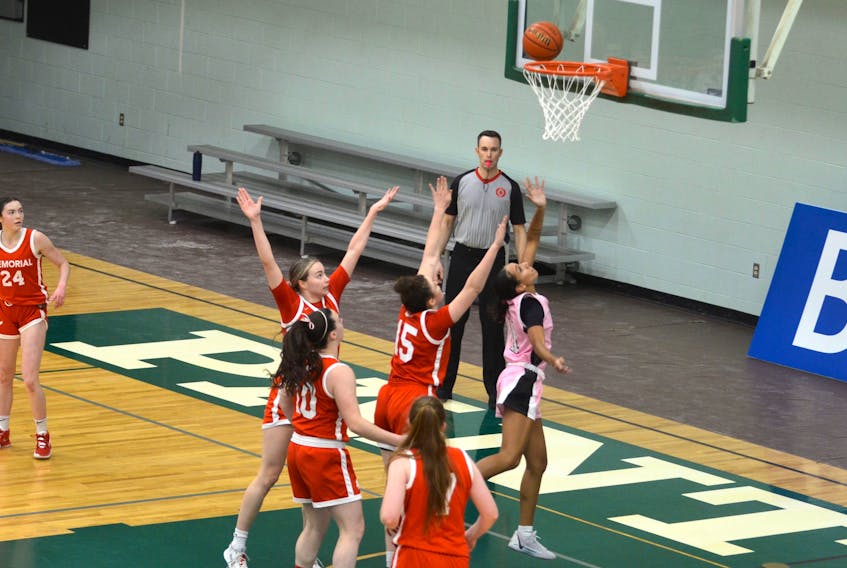 The UPEI Panthers’ Lauren Rainford, pink jersey, drives to the basket and gets a shot off despite being closely guarded by the Memorial Sea-Hawks in an Atlantic University Sport (AUS) Women’s Basketball Conference game in Charlottetown on Feb. 9. Rainford scored 26 points in the game and became the eighth UPEI women’s basketball player to surpass 1,000 career points.