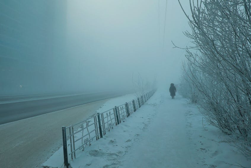 A pedestrian walks along a street on a frosty day in Yakutsk, Russia, December 5, 2023. Temperatures in parts of the Sakha Republic, also known as Yakutia and located in the northeastern part of Siberia, went below minus 50 degrees Celsius (minus 58 degrees Fahrenheit) on December 5.