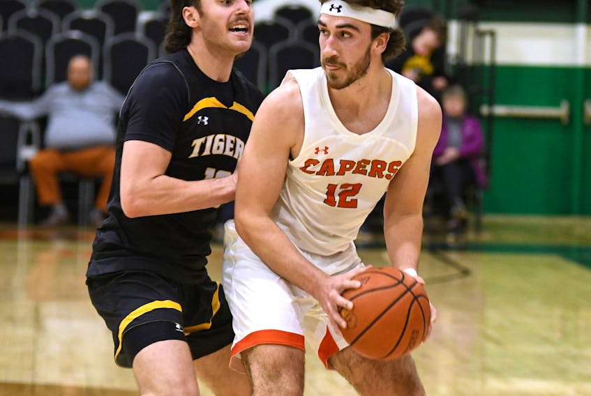 Sydney’s Mitchell Mersereau, right, had a game-high 25 points in the Cape Breton Capers men’s basketball team’s victory over the Dalhousie Tigers at Sullivan Field House in Sydney. Mersereau is shown attempting to get by a Tigers defender. CONTRIBUTED/VAUGHAN MERCHANT, CBU ATHLETICS