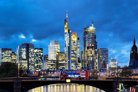 A double decker bus passes the skyline with its dominating banking district in Frankfurt, Germany, November 8, 2023. 