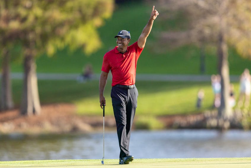 Dec 19, 2021; Orlando, Florida, USA; Tiger Woods reacting to Cameron Kuchar draining a long putt on the 17th green during the final round of the PNC Championship golf tournament at Grande Lakes Orlando Course. Mandatory Credit: Jeremy Reper-USA TODAY Sports/File Photo