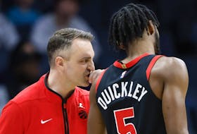 Toronto Raptors head coach Darko Rajakovic, left, talks to guard Immanuel Quickley during a game against the Charlotte Hornets in Charlotte, N.C., Wednesday, Feb. 7, 2024. 