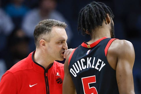 Toronto Raptors head coach Darko Rajakovic, left, talks to guard Immanuel Quickley during a game against the Charlotte Hornets in Charlotte, N.C., Wednesday, Feb. 7, 2024. 