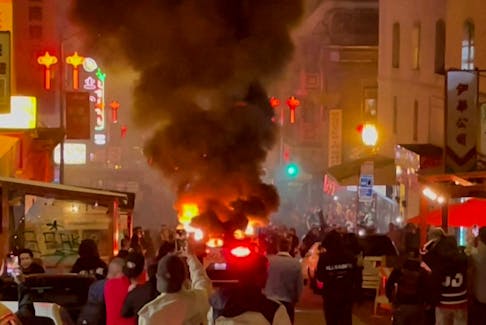 A Waymo self-driving robotaxi, owned by Alphabet's autonomous driving unit, is engulfed in flames after the San Francisco Fire Department said in a statement on social media that fireworks were thrown inside the vehicle, in San Francisco, California February 10, 2024 in a still image from video.  Courtesy of Michael Vandi/ via