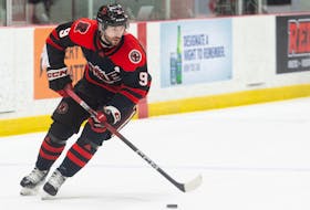 UNB Reds forward Austen Keating carries the puck into the offensive zone against the UPEI Panthers during an Atlantic university hockey game Saturday night in Fredericton. - UNB Athletics