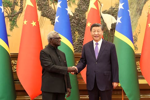 Chinese President Xi Jinping and Solomon Islands Prime Minister Manasseh Sogavare shake hands at the Great Hall of the People in Beijing, China July 10, 2023. cnsphoto via