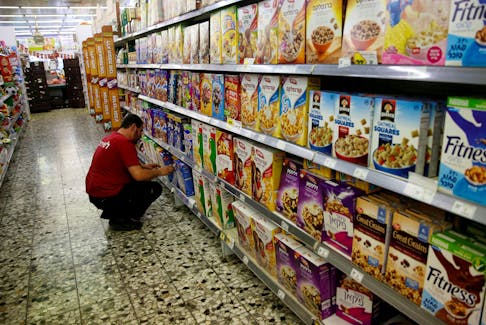 An employee arranges cereal boxes for sale at a supermarket in Jerusalem June 19, 2016.